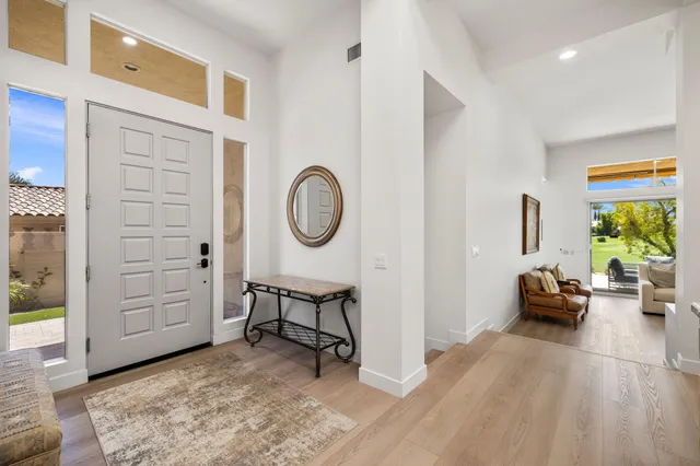 a living room with fireplace furniture and a large window