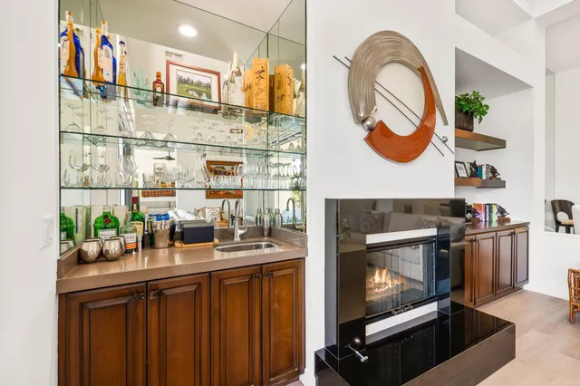 a living room with furniture kitchen view and a large window