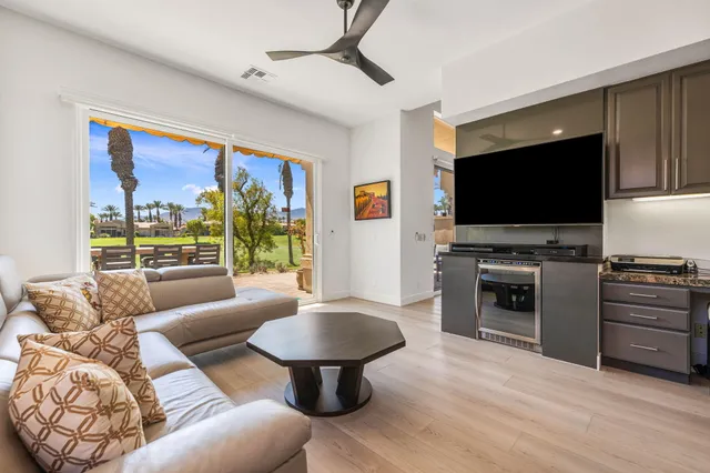 a kitchen with granite countertop a refrigerator and a stove top oven