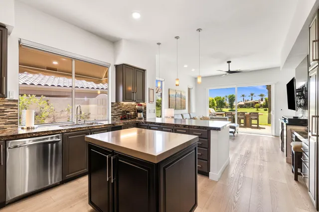 a view of a patio with a table and chairs next to a yard