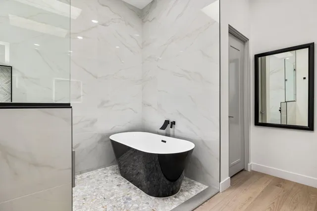 a bathroom with a shower sink and mirror