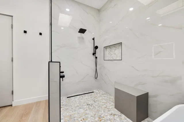 a bed sitting in a bedroom next to a window