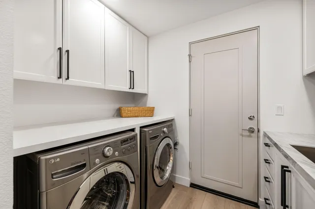 a view of a patio with couches and table and chairs and potted plants