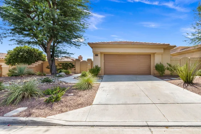 a view of a patio with couches table and chairs and potted plants