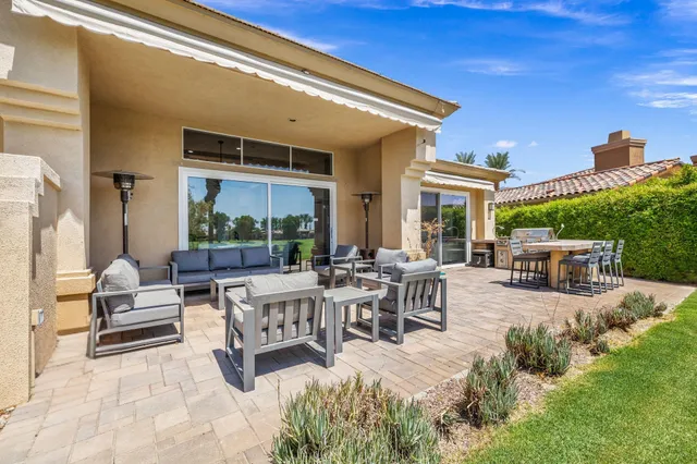 a terrace of a house with outdoor seating