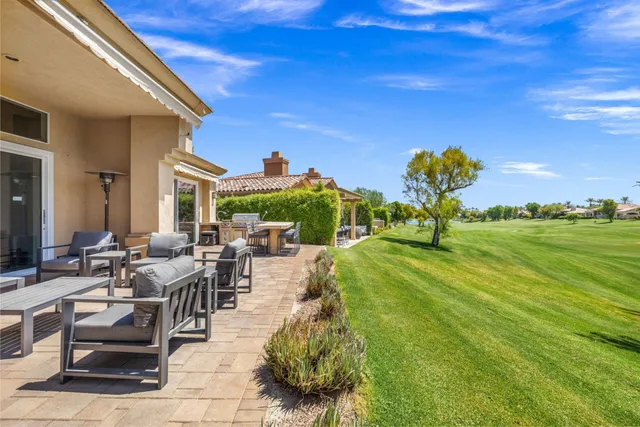 aerial view of a house with a yard and large trees