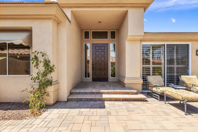a living room with fireplace furniture and a large window