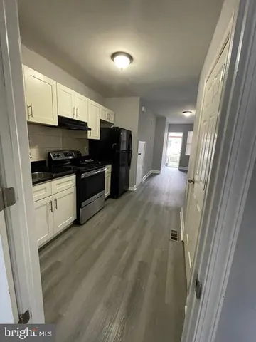 a kitchen with stainless steel appliances a refrigerator a sink a stove top oven