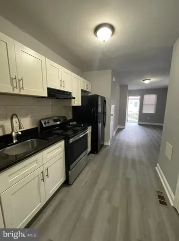 a kitchen that has a lot of cabinets in it and appliances