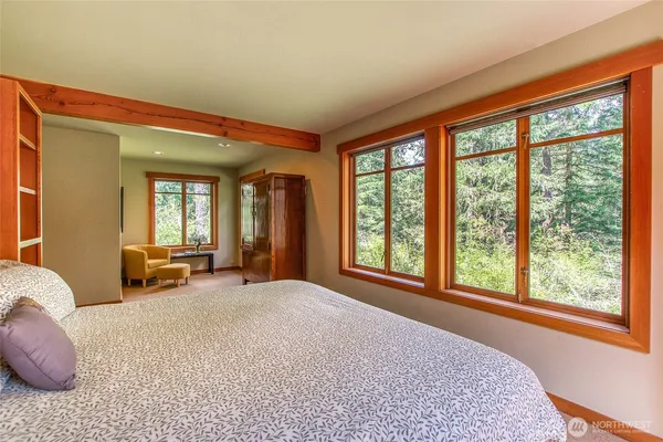 a spacious bedroom with a large bed and a large window