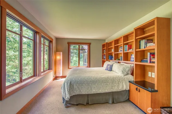 a bedroom with a large bed and a large window
