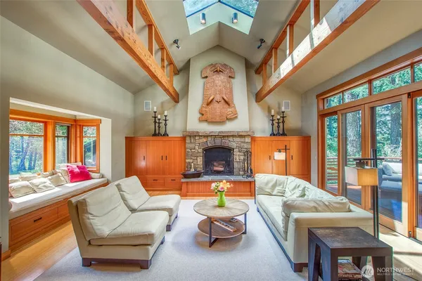 a living room with furniture a fireplace and a large window