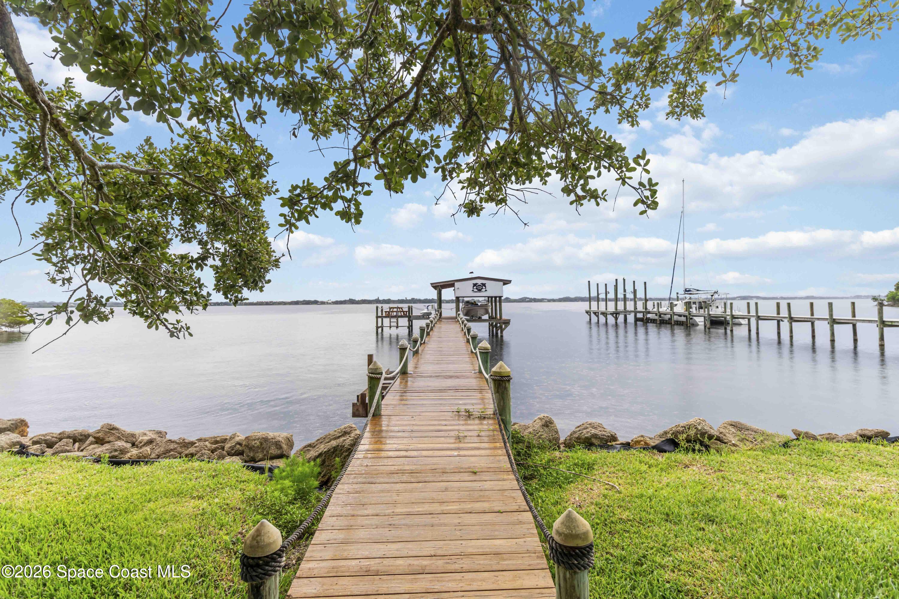 110 Barnacle Place Rockledge, FL 32955 - Photo 8 of 71 a lake view with a wooden bridge