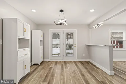 a view of empty room with wooden floor and window
