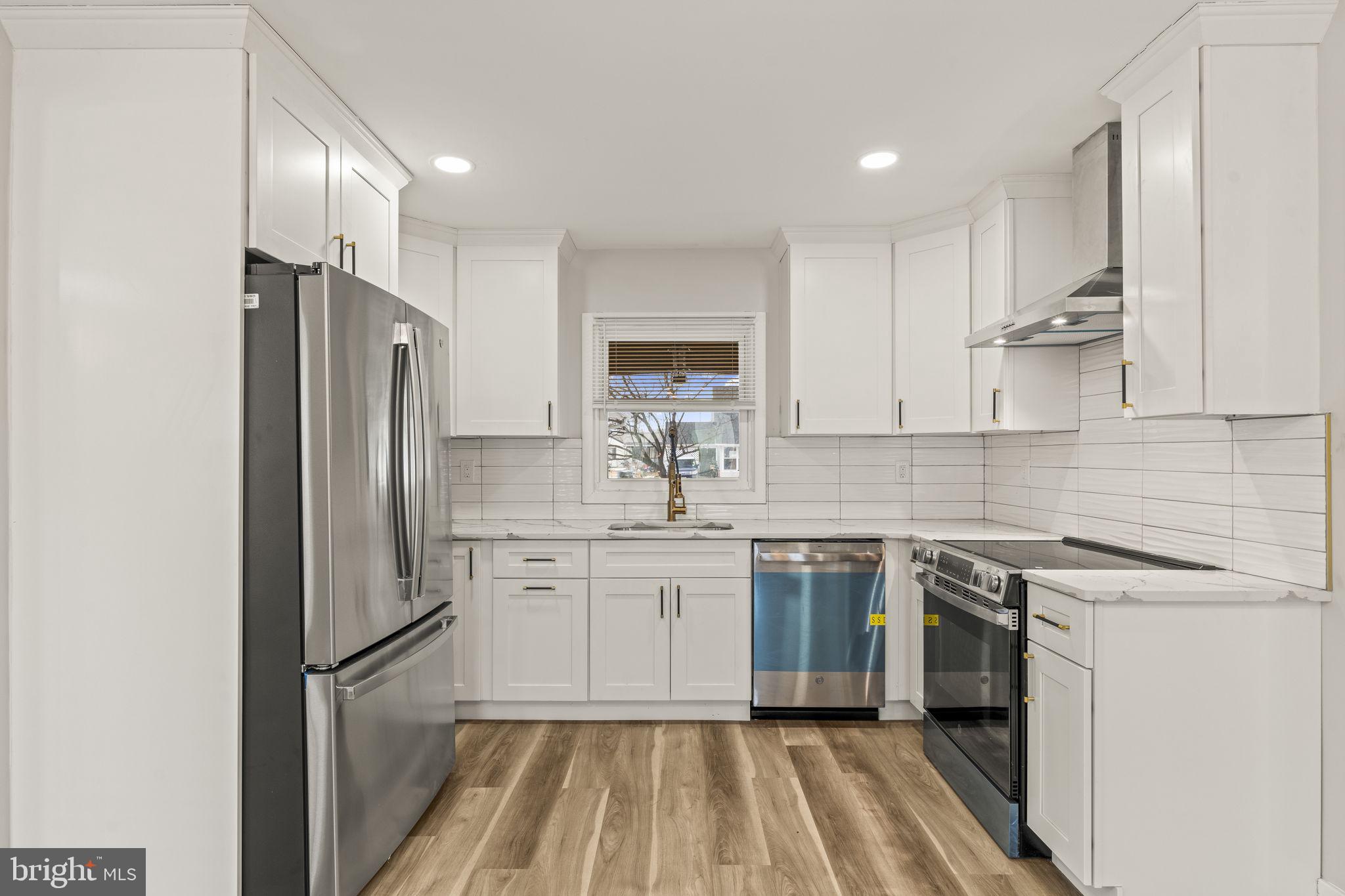 24 Pilgrim Lane Willingboro, NJ 08046 - Photo 18 of 40 a kitchen with a sink stainless steel appliances and white cabinets