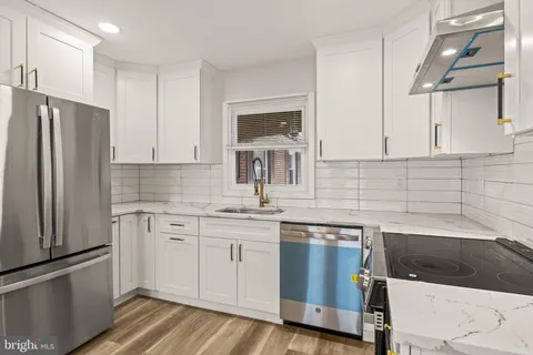 a kitchen with a sink stove and refrigerator
