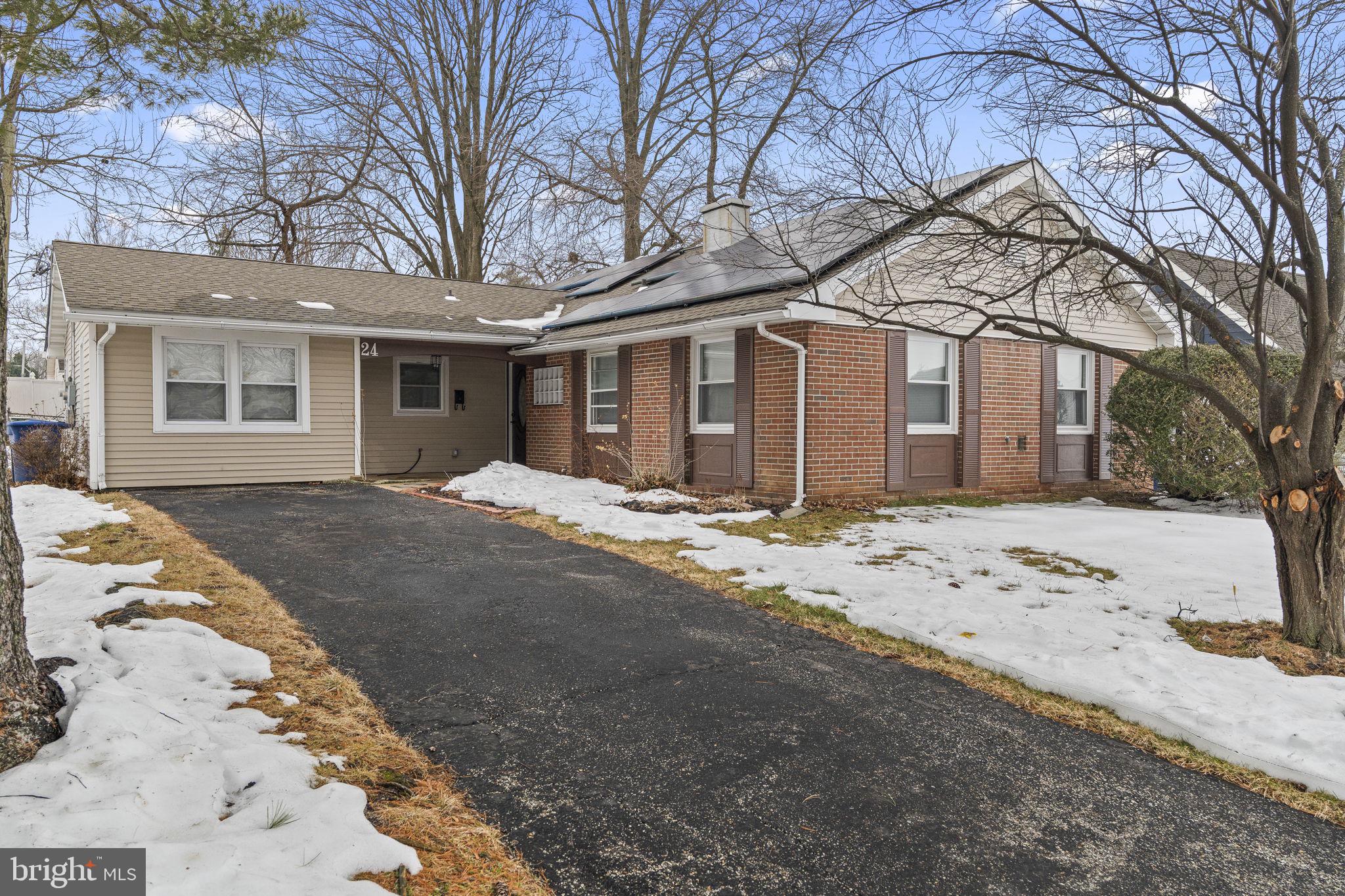 24 Pilgrim Lane Willingboro, NJ 08046 - Photo 2 of 40 a front view of a house with a yard covered in snow