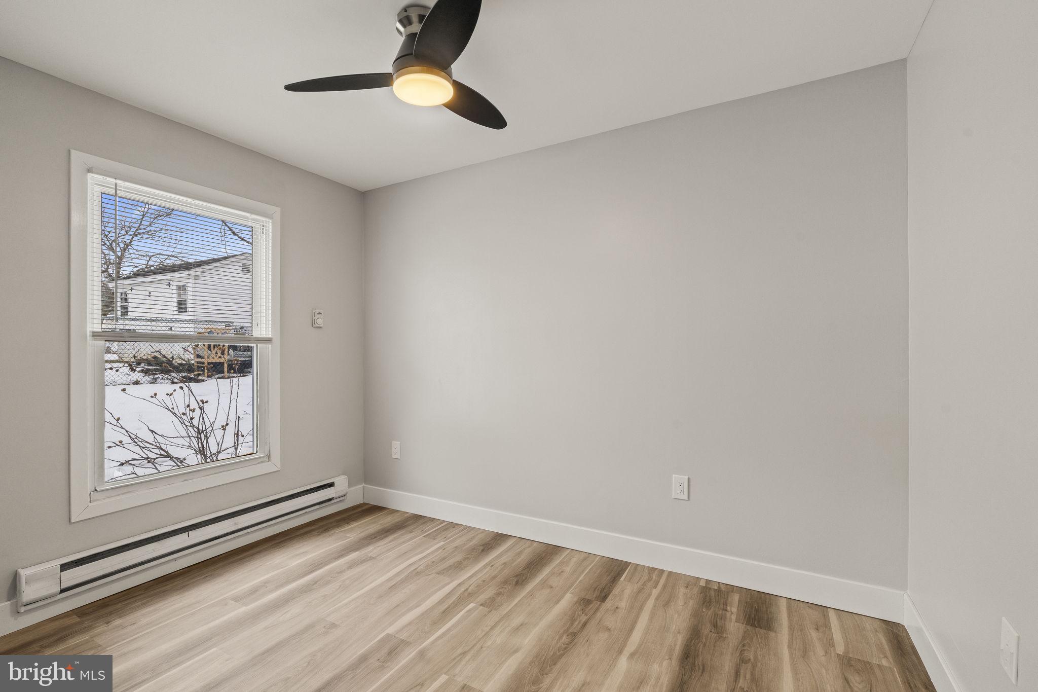 24 Pilgrim Lane Willingboro, NJ 08046 - Photo 21 of 40 a view of an empty room with window and wooden floor