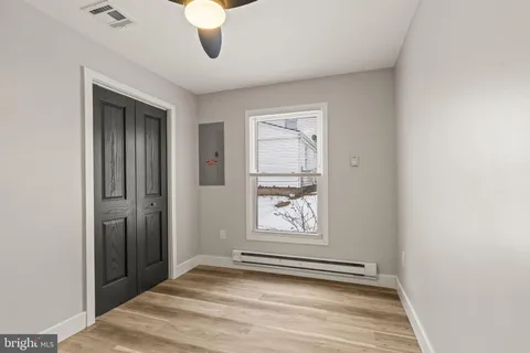 an empty room with windows and closet