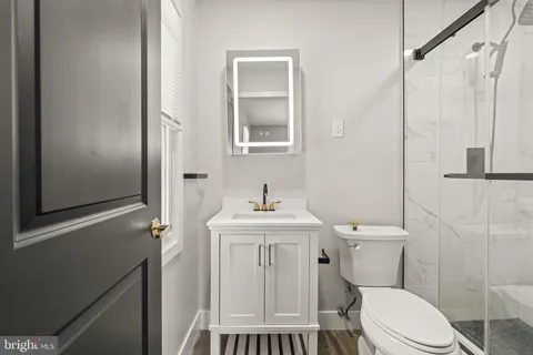 a white toilet sitting next to a bathroom sink
