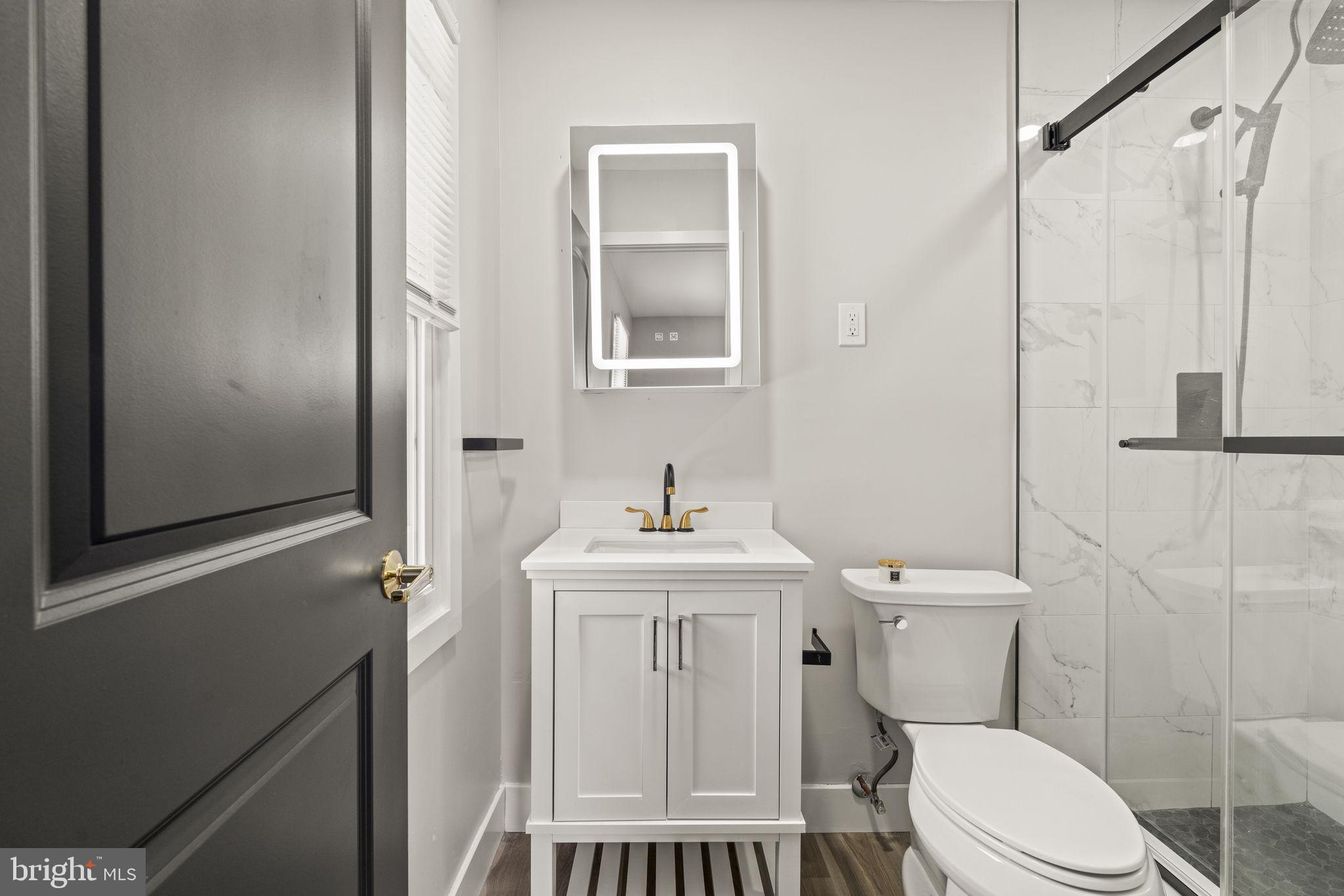 24 Pilgrim Lane Willingboro, NJ 08046 - Photo 37 of 40 a white toilet sitting next to a bathroom sink