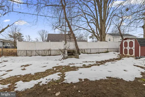a view of a yard covered in snow
