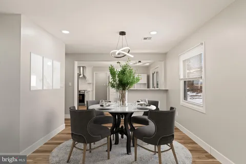 a view of a dining room with furniture and chandelier