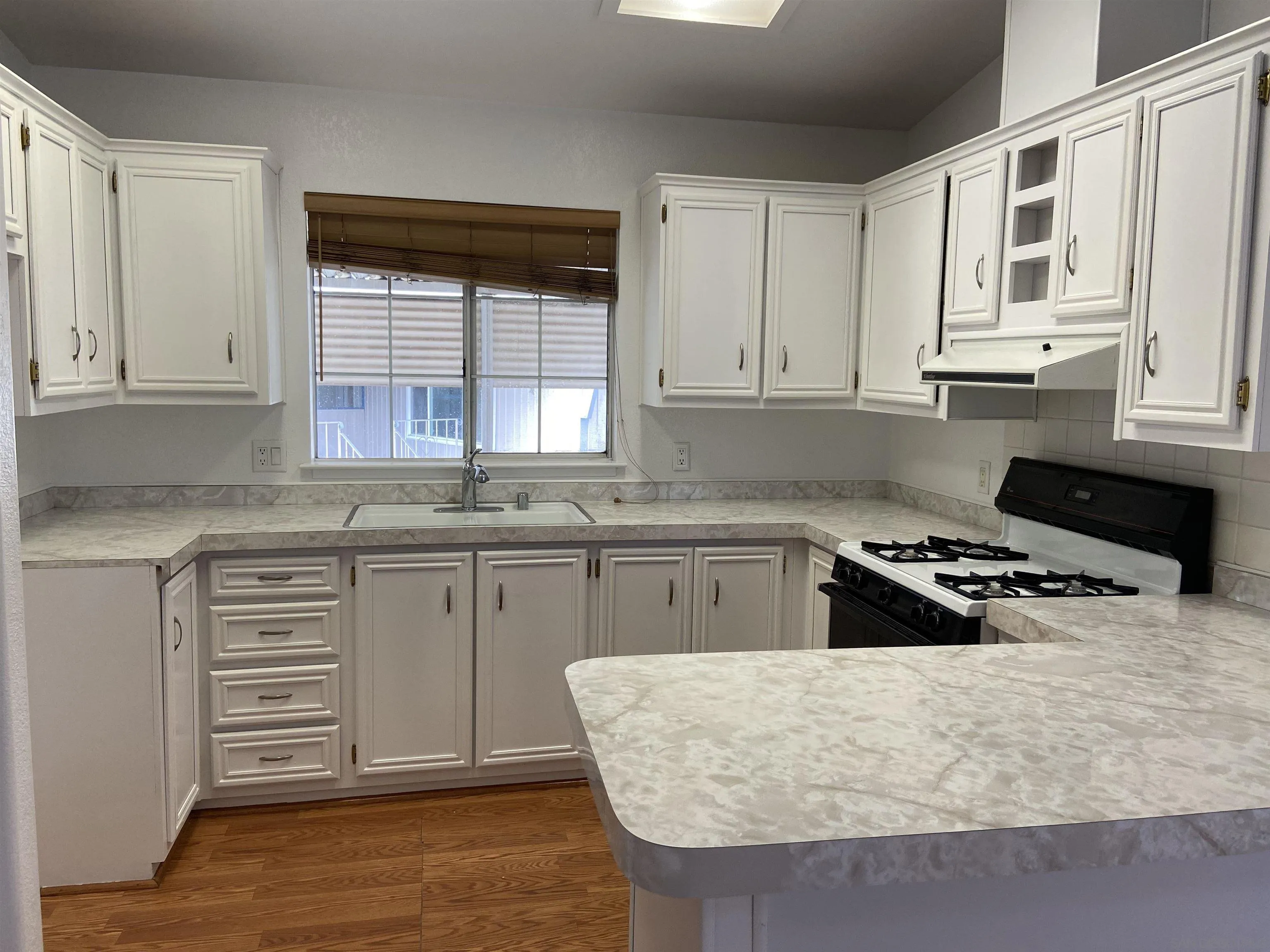 10000 Buena Vista Avenue, Unit 2 Santee, CA 92071 - Photo 3 of 12 a kitchen with granite countertop a sink stove and cabinets