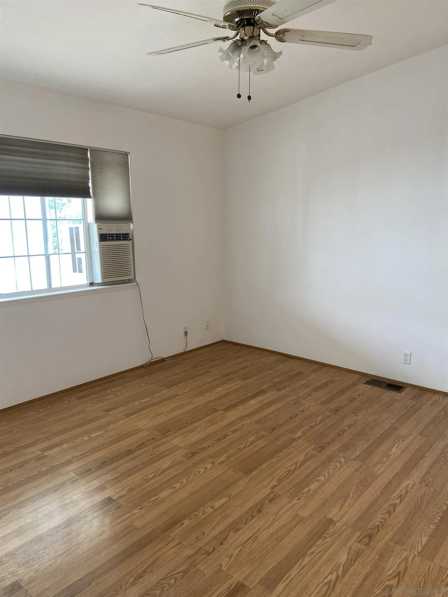 10000 Buena Vista Avenue, Unit 2 Santee, CA 92071 - Photo 5 of 12 an empty room with wooden floor and windows