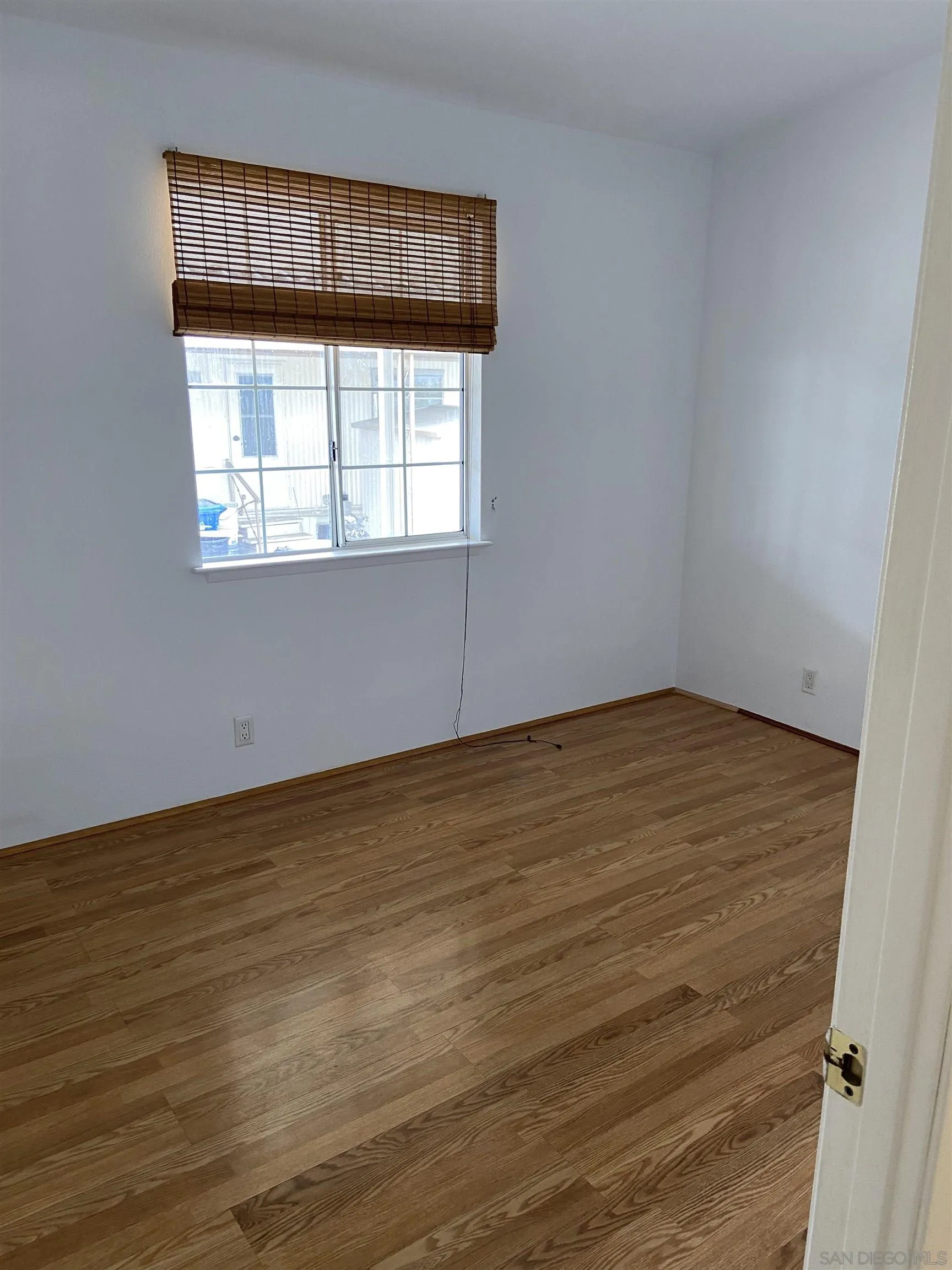 10000 Buena Vista Avenue, Unit 2 Santee, CA 92071 - Photo 6 of 12 a view of an empty room with wooden floor and a window