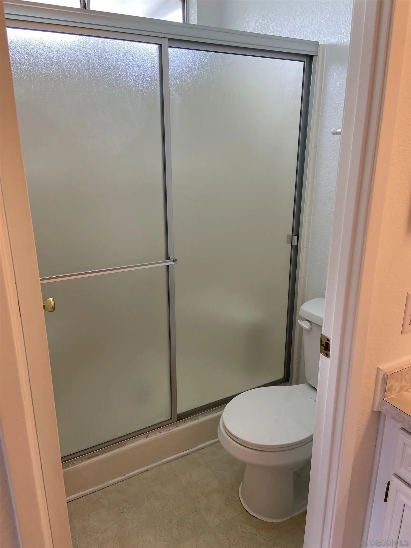 10000 Buena Vista Avenue, Unit 2 Santee, CA 92071 - Photo 8 of 12 a white toilet sitting next to a shower