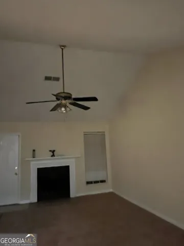 a view of a room with window and a ceiling fan