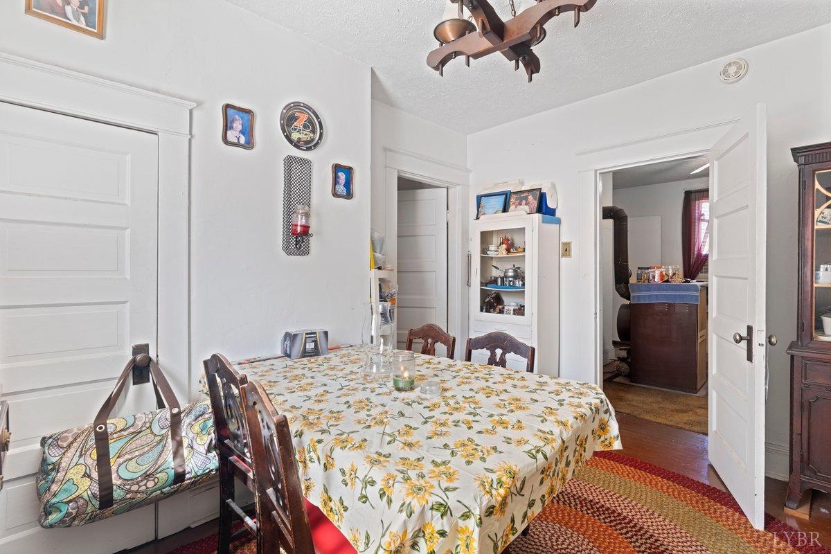 2608 Old Forest Road Lynchburg, VA 24501 - Photo 12 of 17 a bedroom with a bed and a chandelier