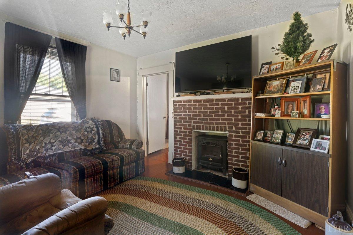 2608 Old Forest Road Lynchburg, VA 24501 - Photo 3 of 17 a living room with furniture a flat screen tv and a fireplace