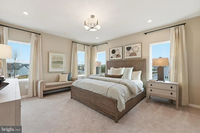 a spacious bedroom with a bed and a chandelier