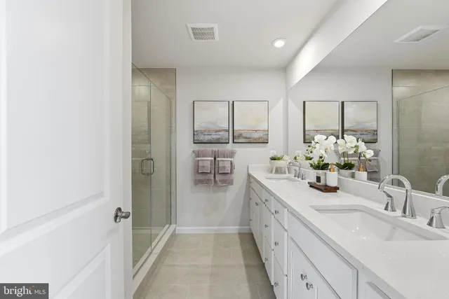 a bathroom with a double vanity sink and a mirror