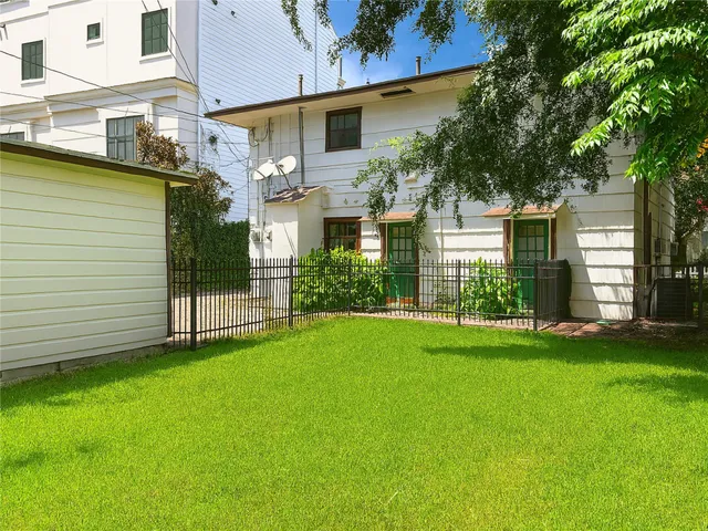 a view of a house with a yard and sitting area