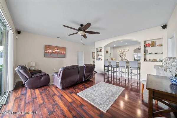 a living room with furniture and a wooden floor
