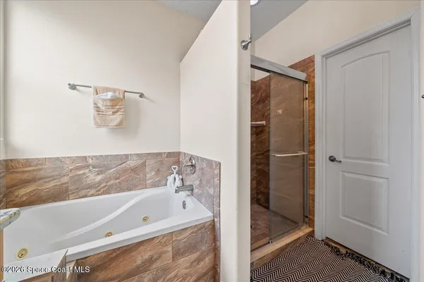a bathroom with a tub and shower