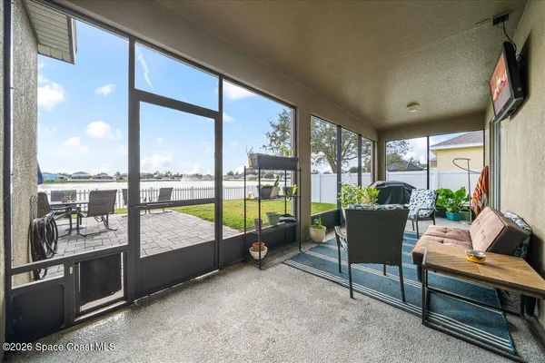 a living room with furniture tv and a floor to ceiling window