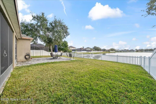 a view of a house with a yard and sitting area
