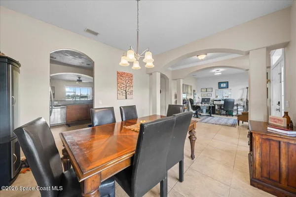 a view of a dining room with furniture and a chandelier