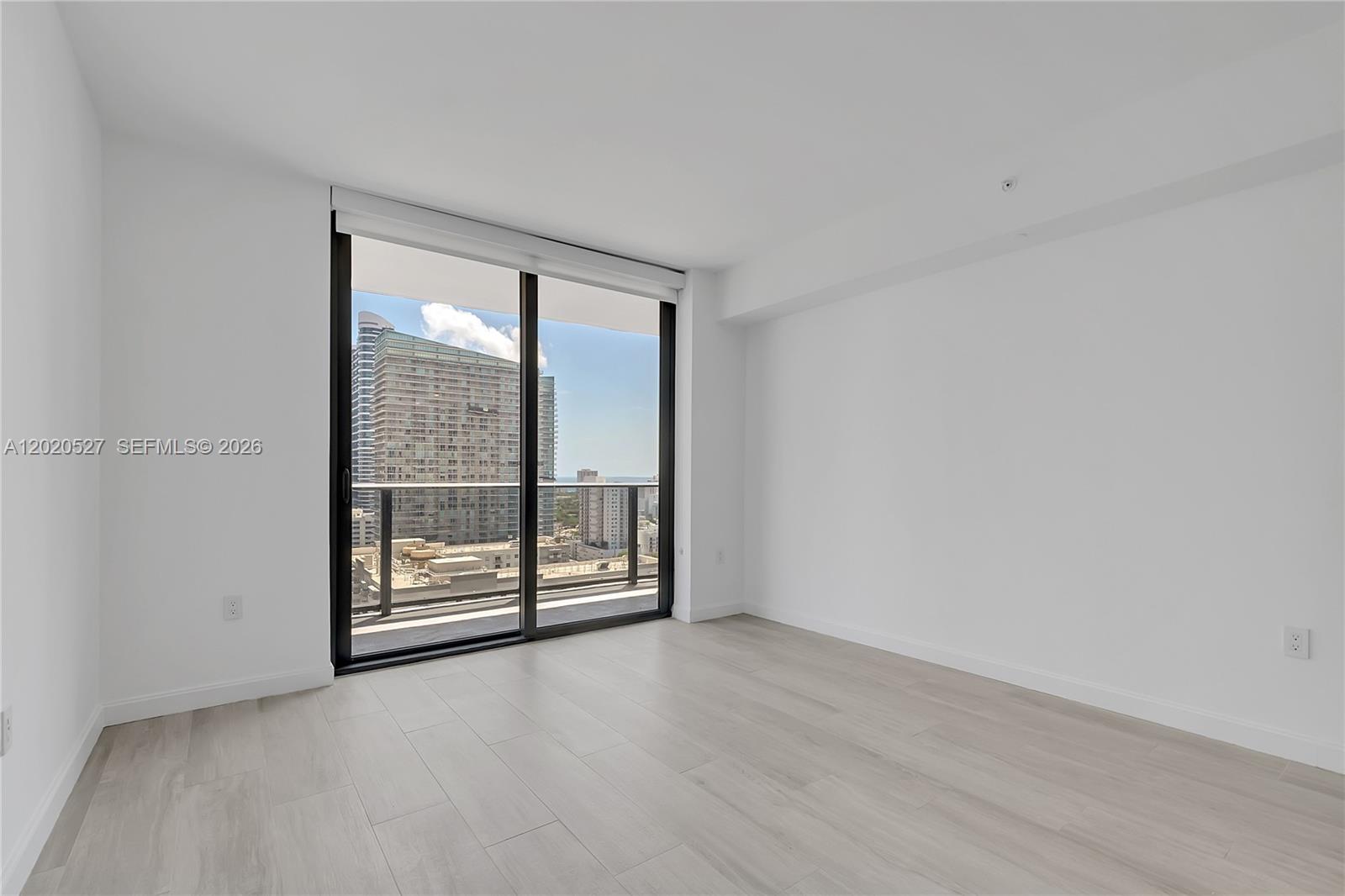 45 Southwest 9th Street, Unit 2105 Miami, FL 33130 - Photo 15 of 27 wooden floor and window in an empty room