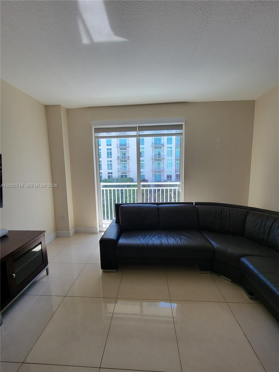 7290 Southwest 90th Street, Unit 403 Miami, FL 33156 - Photo 6 of 18 a living room with a couch and a potted plant