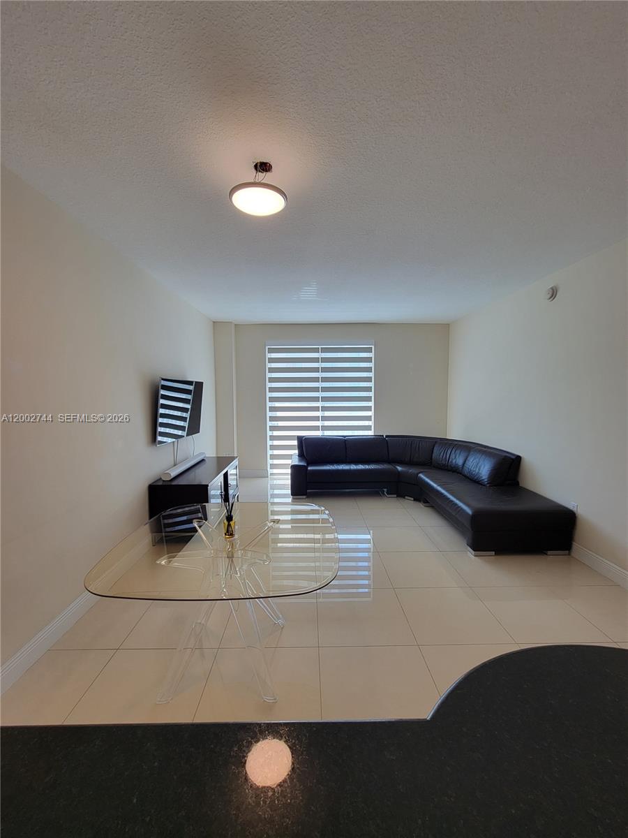 7290 Southwest 90th Street, Unit 403 Miami, FL 33156 - Photo 7 of 18 a living room with furniture and a window