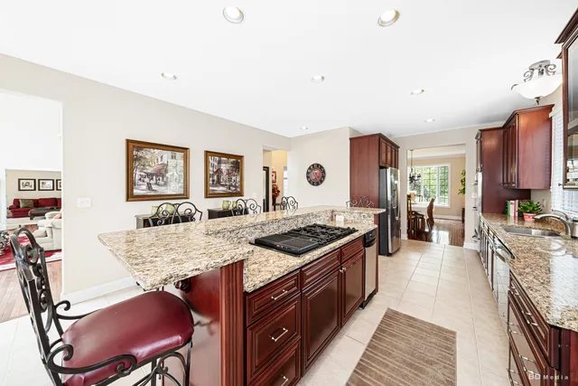 a kitchen with stainless steel appliances granite countertop a stove and a refrigerator