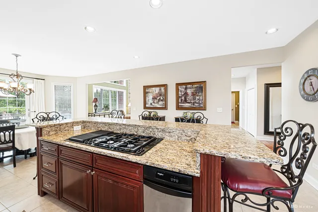 a kitchen with a stove a table and chairs in it