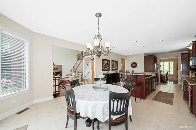 a view of a dining room with furniture and a chandelier