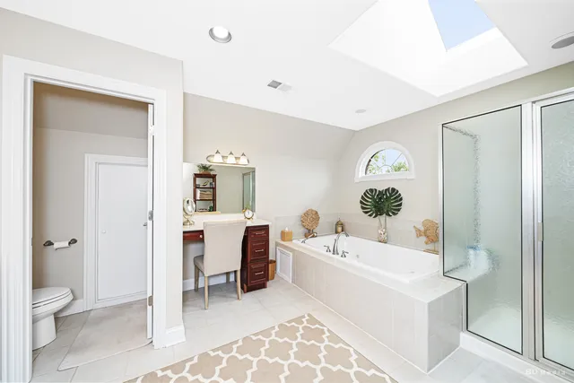 a bathroom with a tub a toilet and a sink