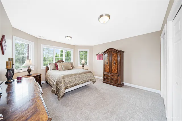 a spacious bedroom with a bed and a couch